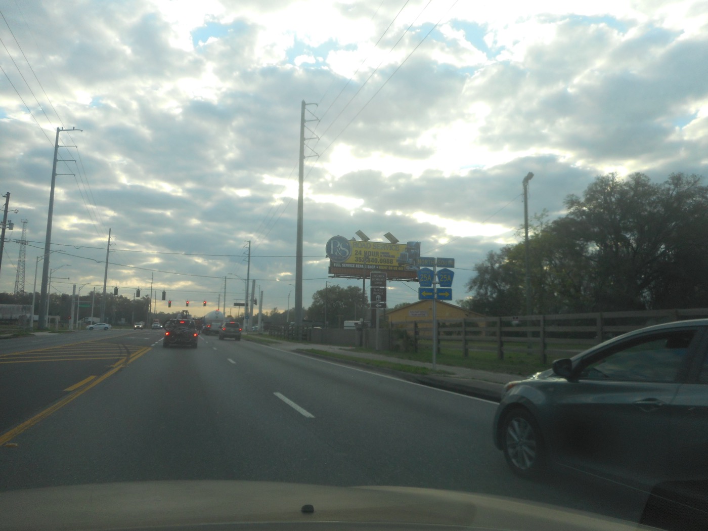 Eastbound State Road 326 approaching the traffic light at County Road 25A, with route signs on the right