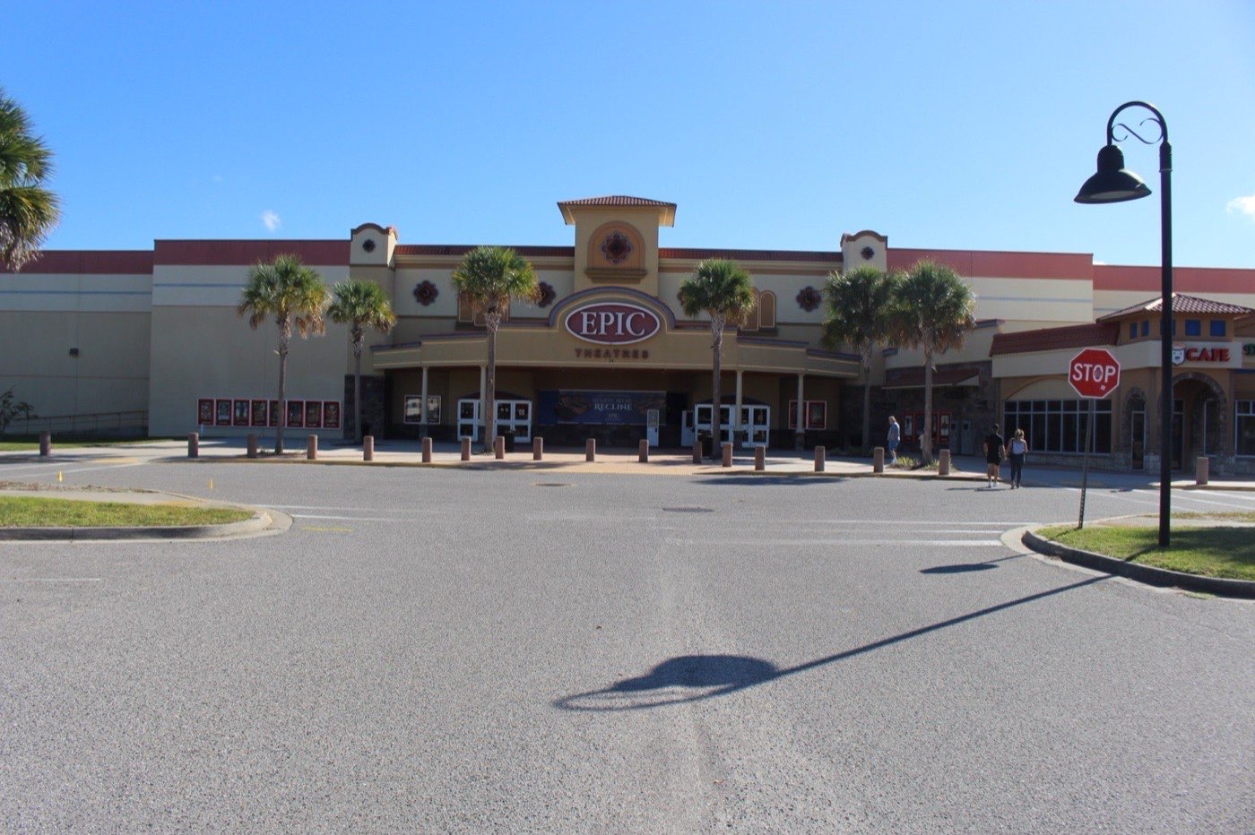Front entrance of the Epic Theatres cinema in St. Augustine, Florida, with palm trees and the Epic sign over the doors