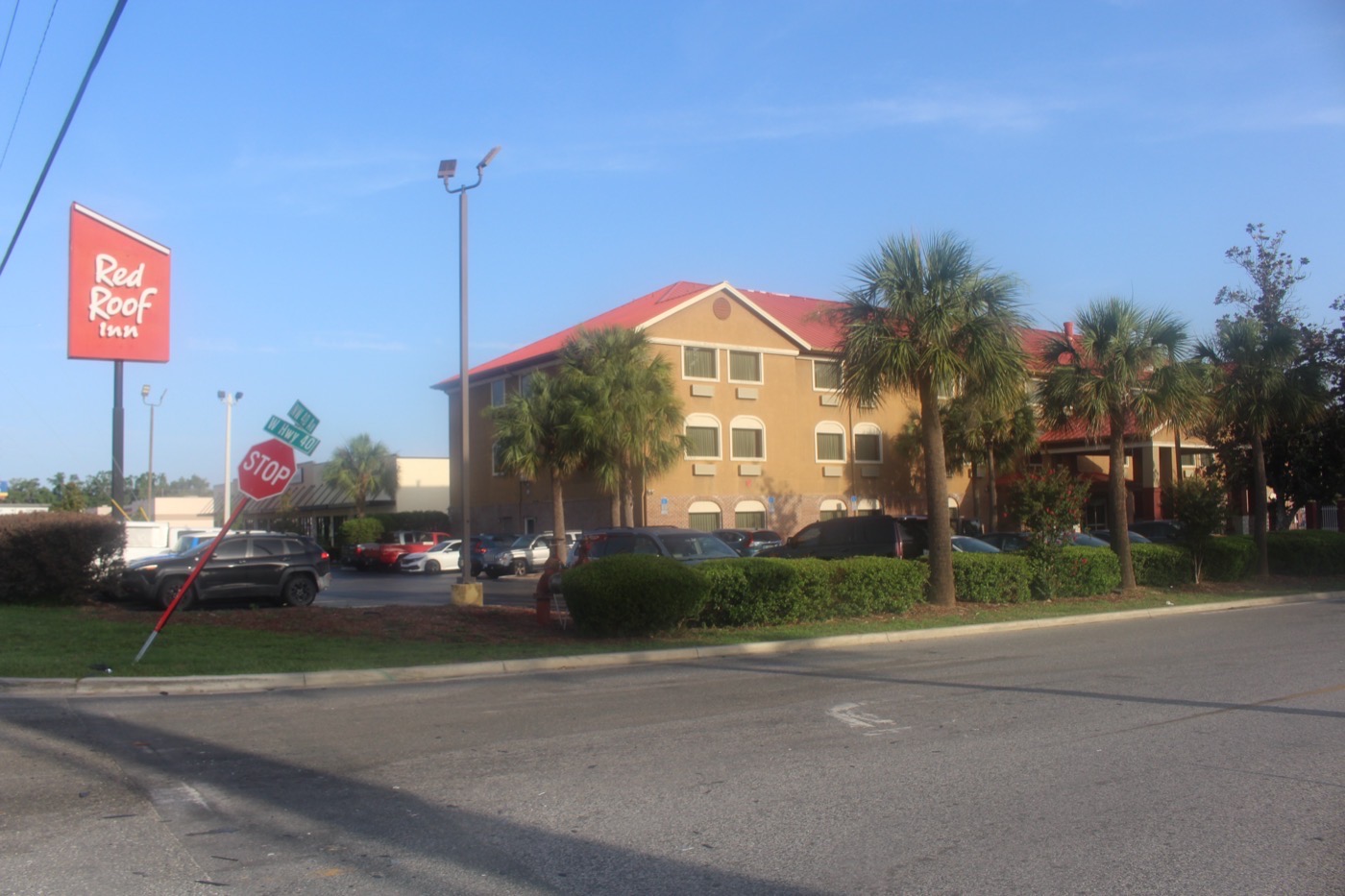 The Red Roof Inn on NW 40th Avenue in Ocala, Florida, with its tall sign, palm trees and parking lot