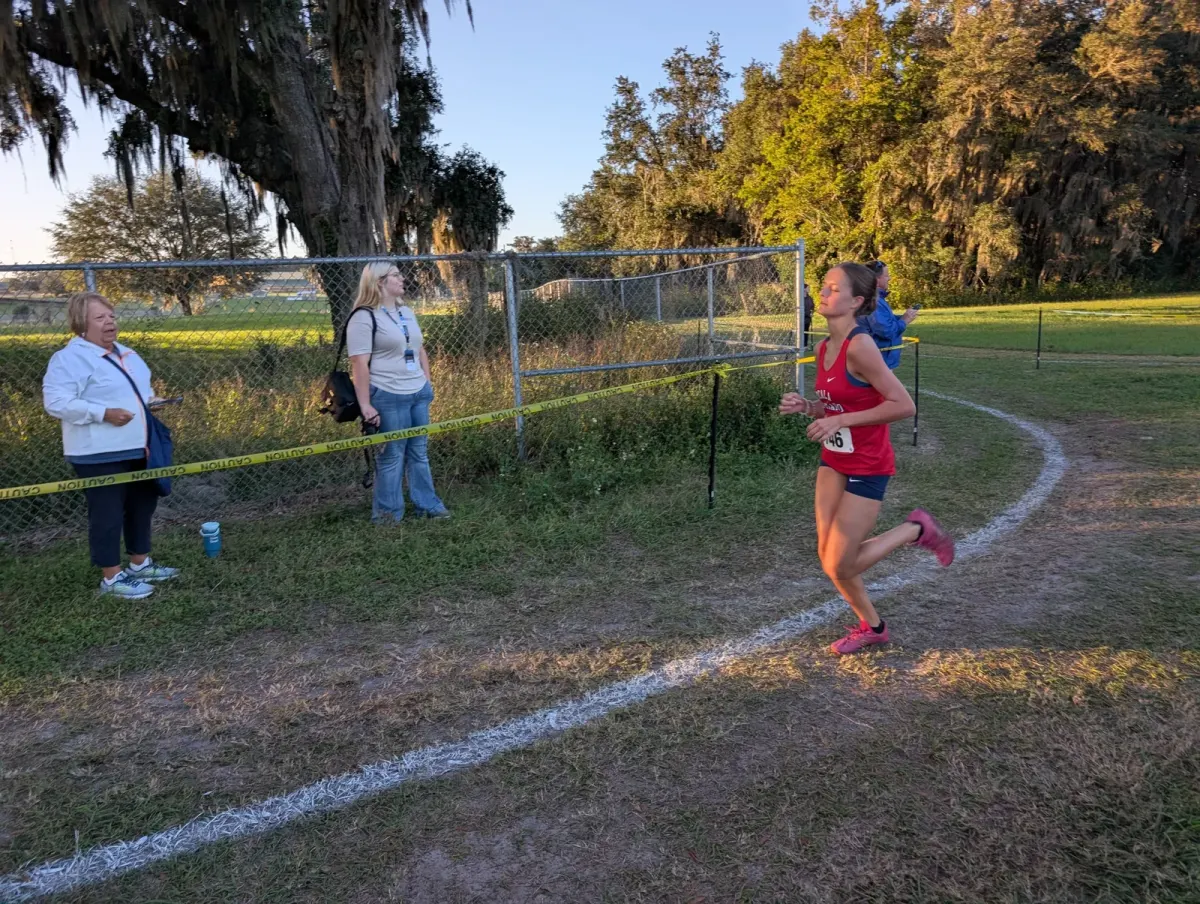 Vanguard sophomore Lyla Hallick running alone at the front of the girls' race at the 2026 Marion Athletic Conference cross country championships