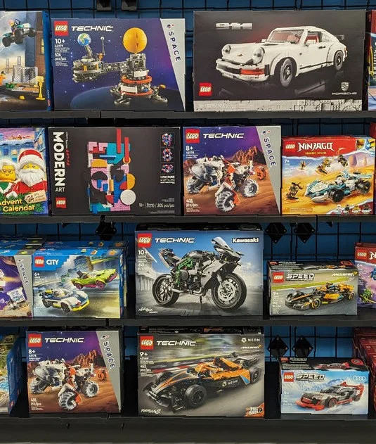 Shelves of new boxed LEGO Technic, Speed Champions, City, Ninjago and Art sets at a Bricks & Minifigs store