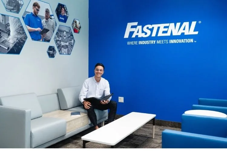 The Connection Hub by Fastenal meeting room inside the College of Central Florida Center for Career Development, with a gray sofa, blue chairs and a Fastenal wall