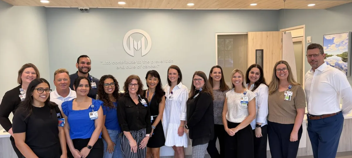 A group of Moffitt Cancer Center team members standing inside the Moffitt First Connect office in Ocala