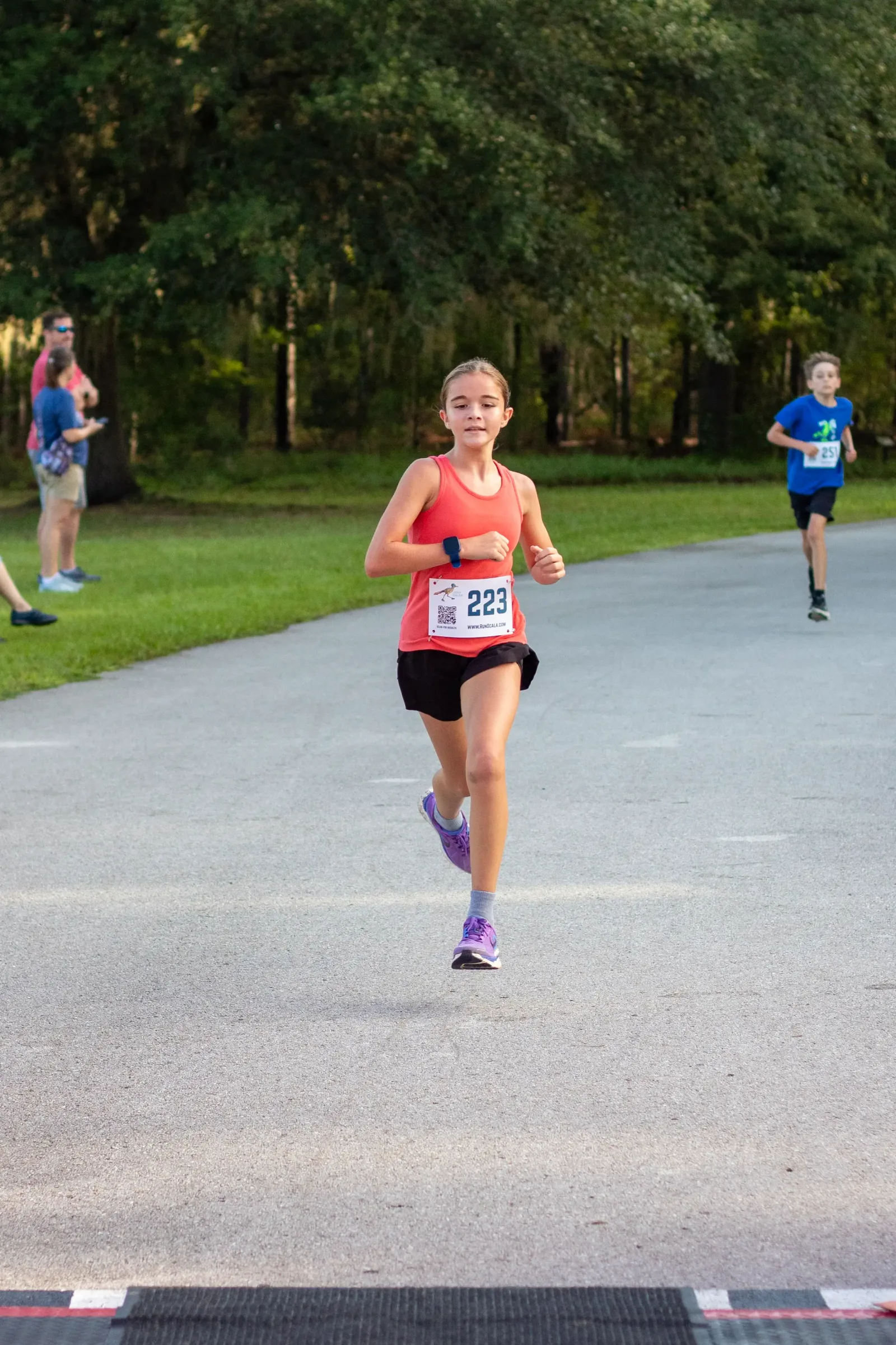 Twyla Martin, bib 223, finishing as the first girl at the 2026 Ocala Kids Run
