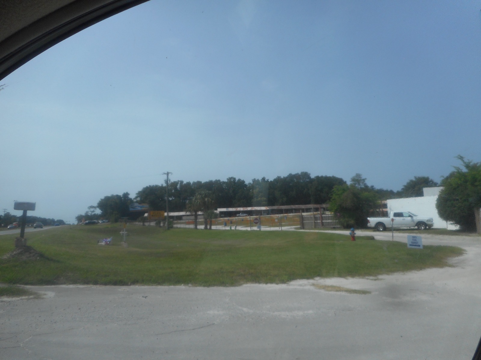 Covered vendor stalls of the flea market on the Ocala Drive-In grounds, seen from the drive beside US 441
