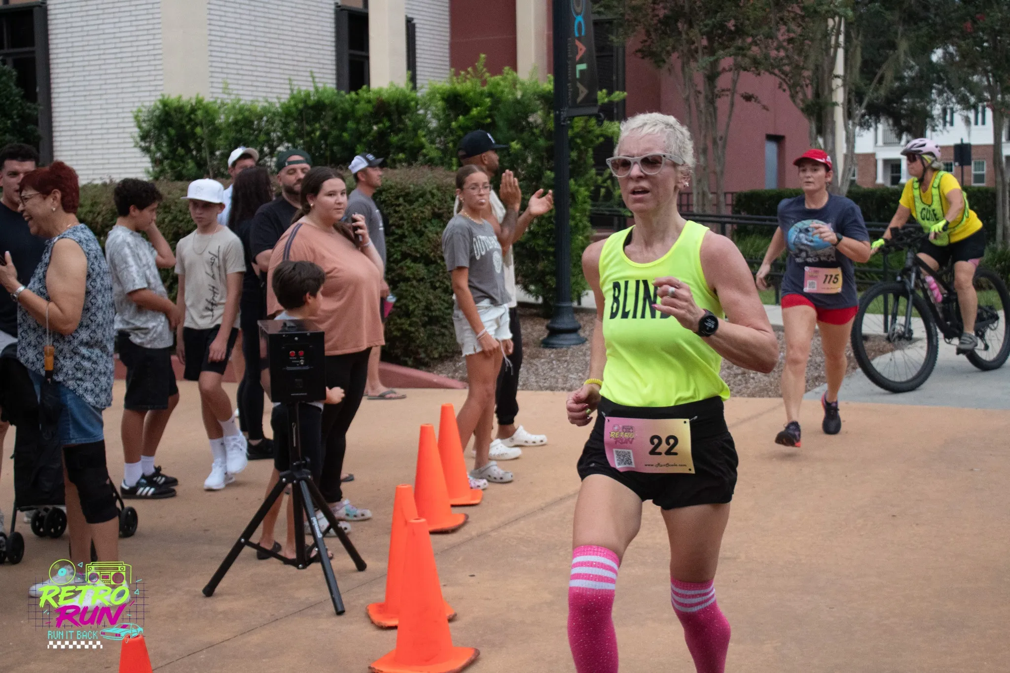 Tasha Moses running with guide runner and assistive technology at the Retro Run 5K