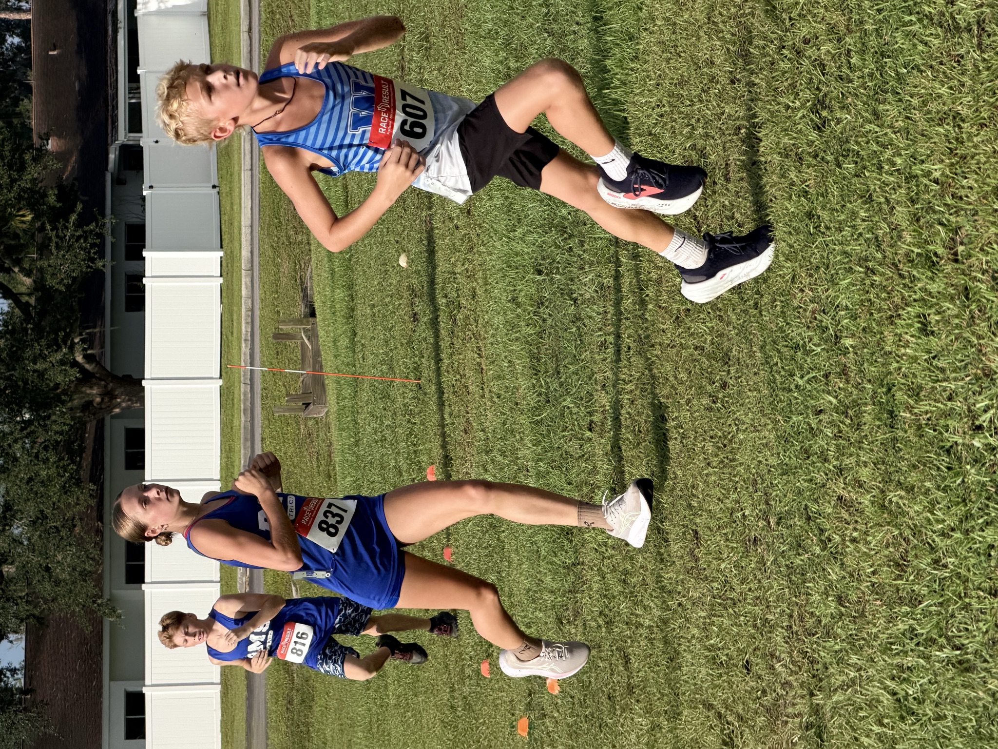 Belleview Middle School runners and a Wildwood runner on the grass course during the middle school 3K at the 2026 Wildwood Invitational